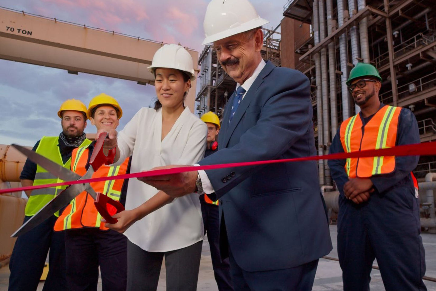 Grand opening ceremony with red extra large scissors.