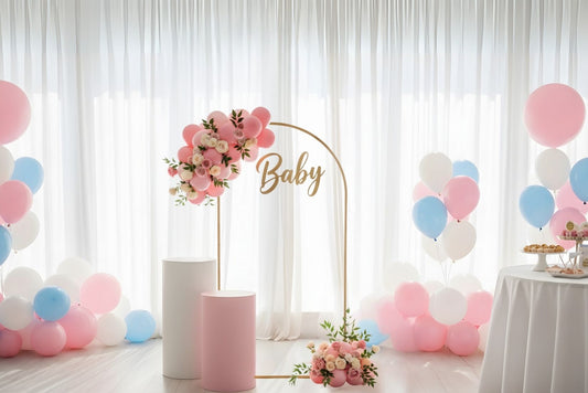 Decorative setup with balloons and floral arch for a baby shower.