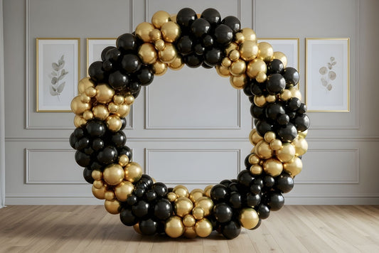 5' circle balloon arch decorated with black and gold balloons