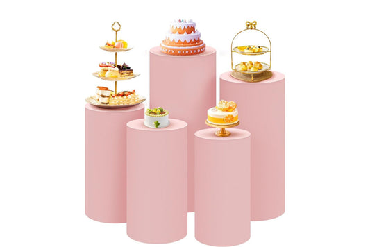 Set of pink pedestal cake stands with various pastries for an event