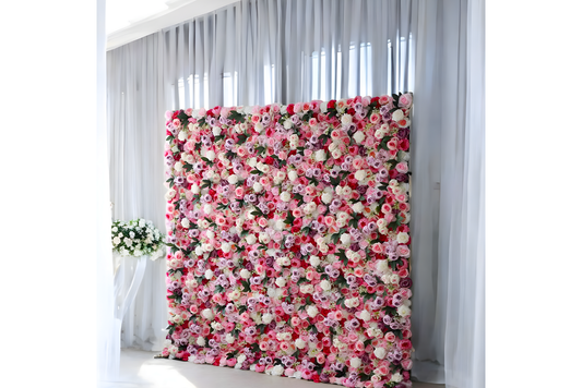 Pink and white flower wall in front of white curtains
