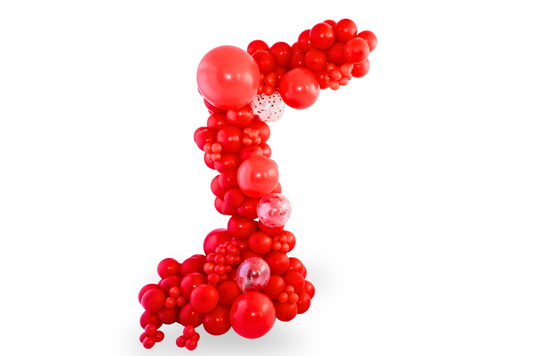 Red balloon garland with mini balloons and clear confetti accents.