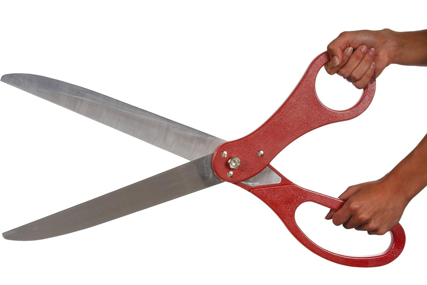 Hand holding giant red maroon ribbon cutting scissors