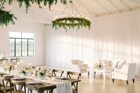 Party room with white event backdrop drapes