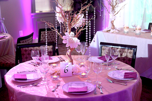Gold manzanita tree table centerpiece with white dahlia flowers and hanging crystals. Centerpiece is available for rent.