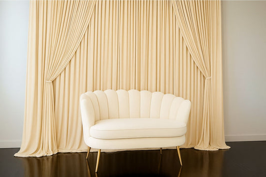 Beige pipe and drape backrop rental with off white chair
