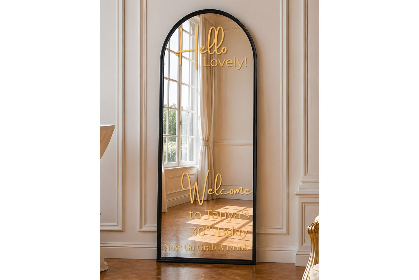 Full-length mirror for rent with decorative text in a room with white walls and wooden floor.