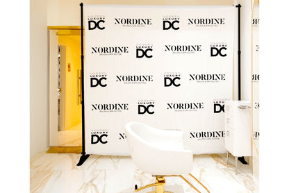 Black and white step and repeat banner used for salon brand opening launch.