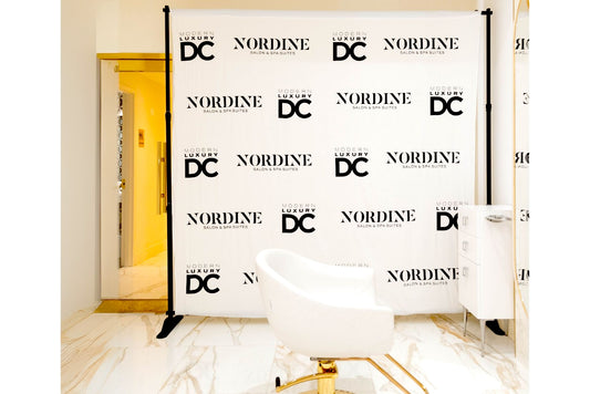 Black and white step and repeat banner used for salon brand opening launch.