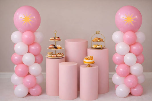 Pink and white balloon column with starburst design.