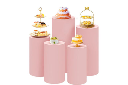 Set of pink pedestal cake stands with various pastries for an event