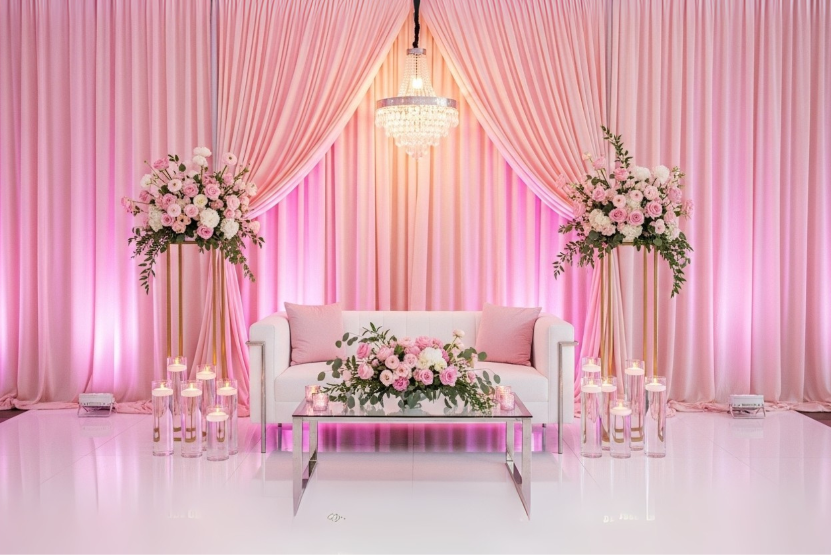 Full room draping with white panels, candles and pink uplighting.