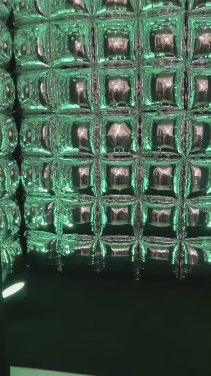 Video of reflective mirror balloon photo booth cube with neon party lights