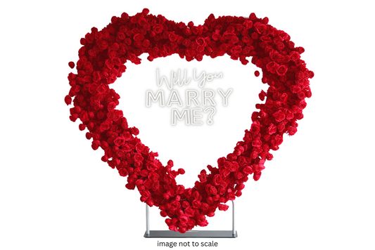 A heart-shaped arch decorated with red faux roses, designed for use as a backdrop for weddings or other events.