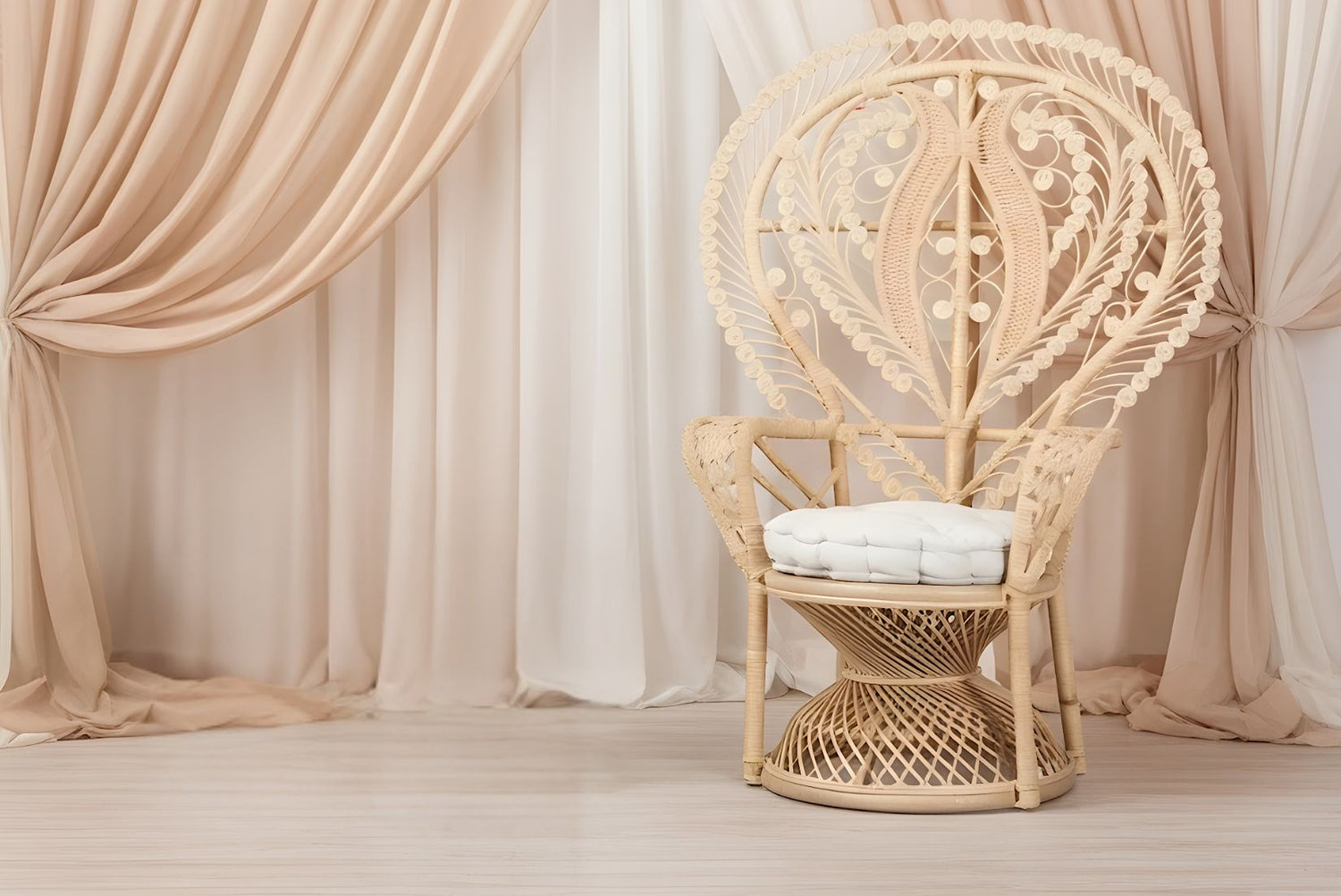 Wicker boho peacock chair with white cushion in a room with beige and white pipe and drape.